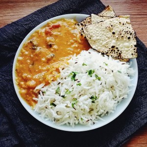 Dal Tadka served with rice and papad, staple meal in South Asia.